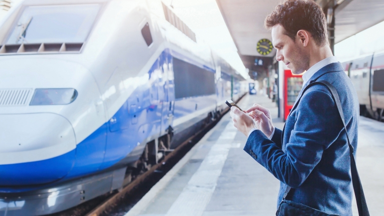 Man checking the Rail Planner app on the platform